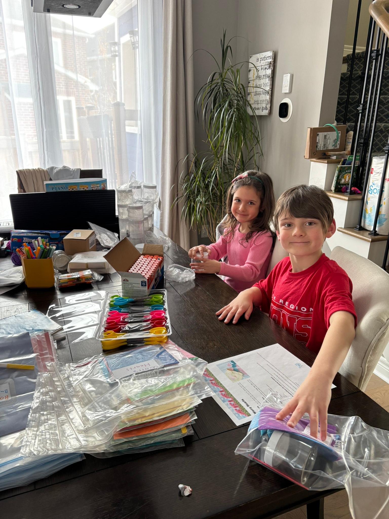 Jackson and Hannah working together on craft kits